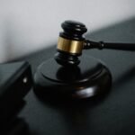 Close-up of a wooden gavel on a desk, symbolizing justice and legal authority.